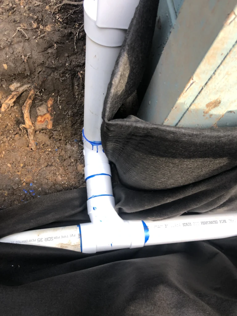 A pipe with a blue tape attached to it. carlos construction