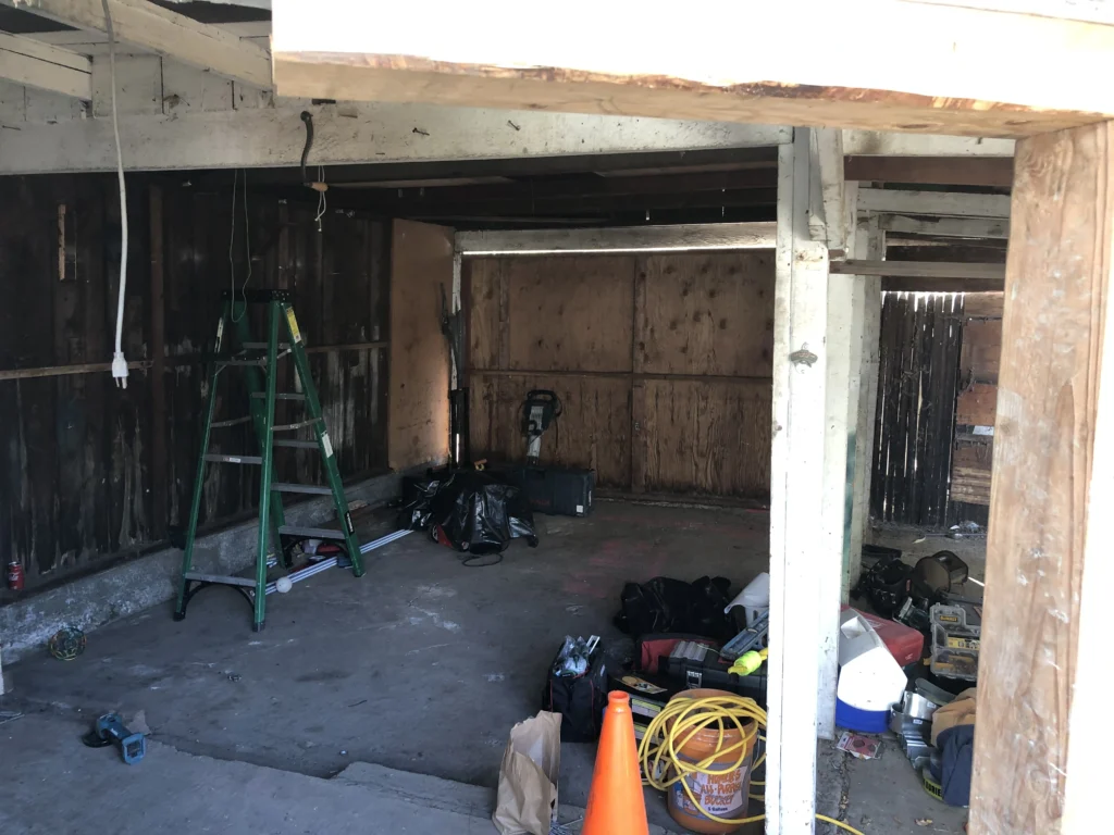 The inside of a garage that is being remodeled. drainage company near me