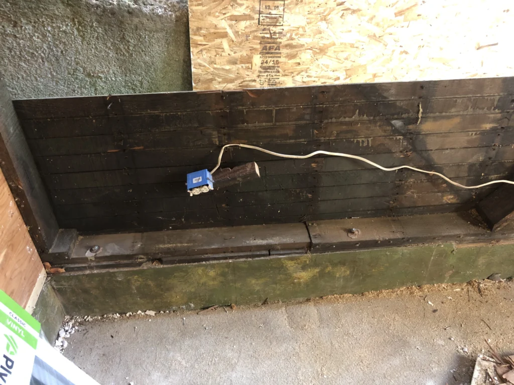 A wooden bench with a wire attached to it. framing contractor